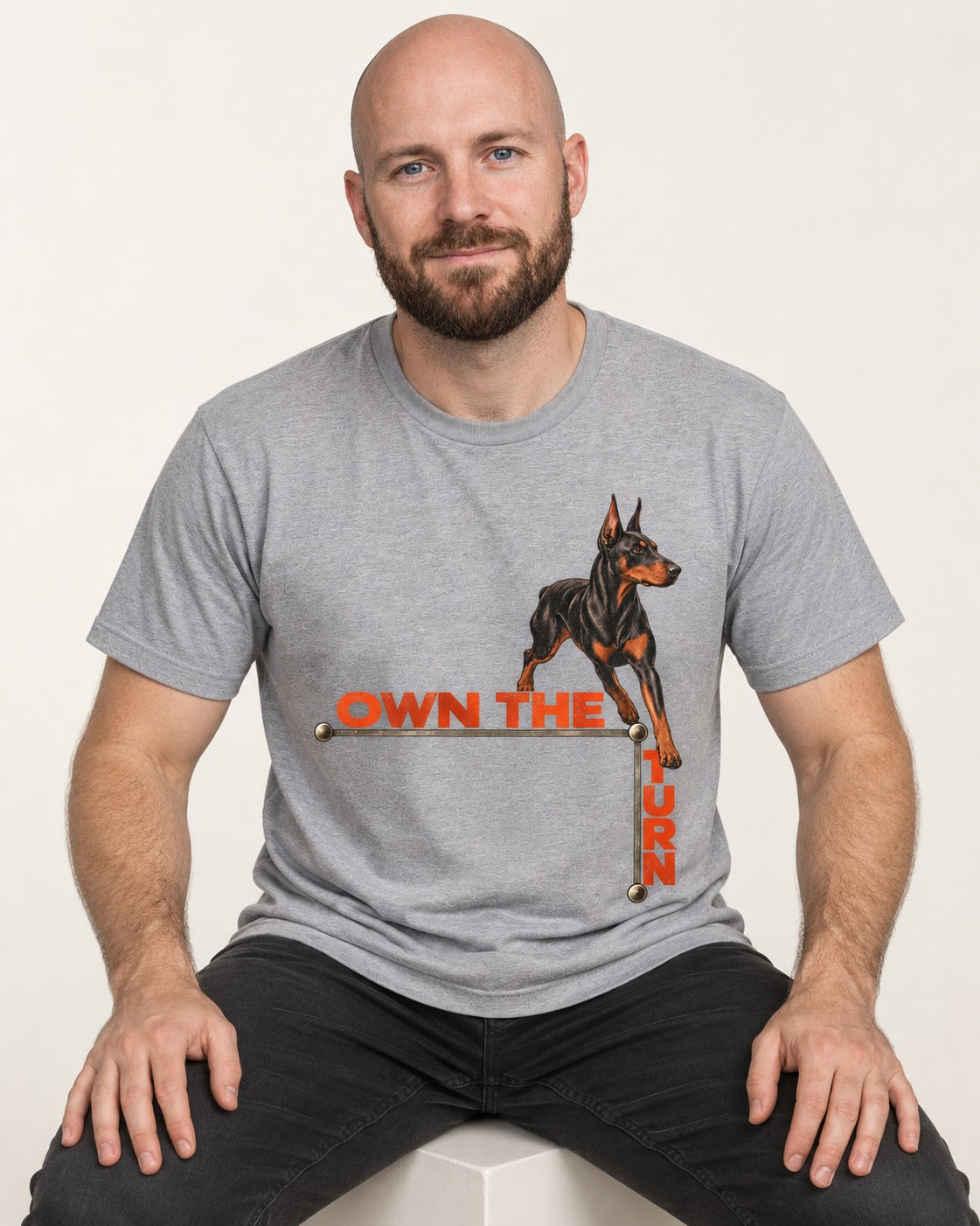 Own the Turn Doberman T-Shirt in Sport Grey, worn by a seated model