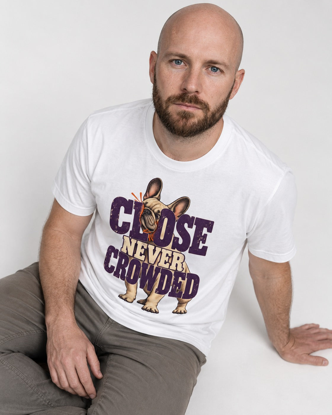 Frenchie Close Never Crowded Peekaboo Type Graphic T-Shirt in White, worn by a seated model