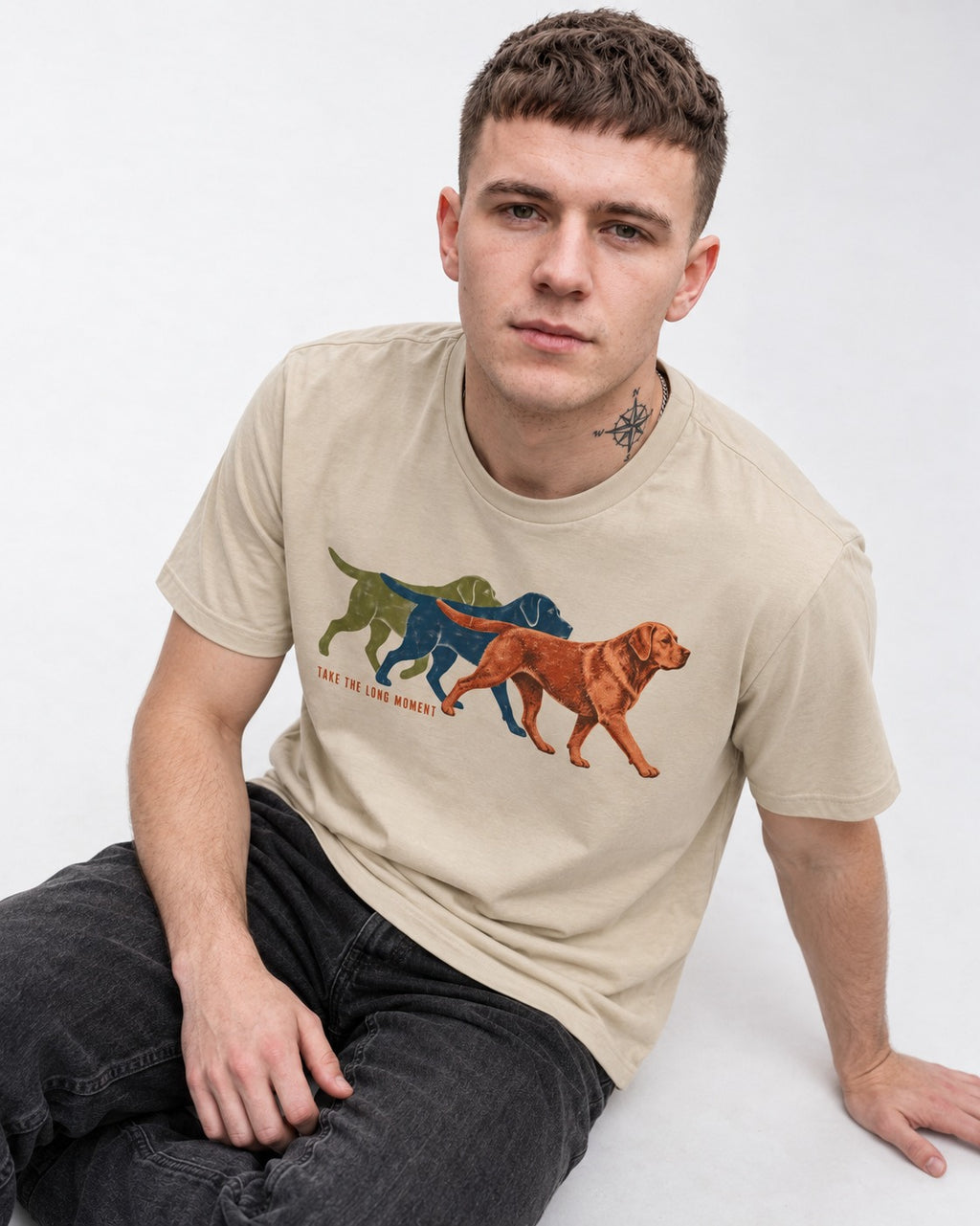 Take the Long Moment Labrador Retriever T-Shirt in Sand, worn by a seated model