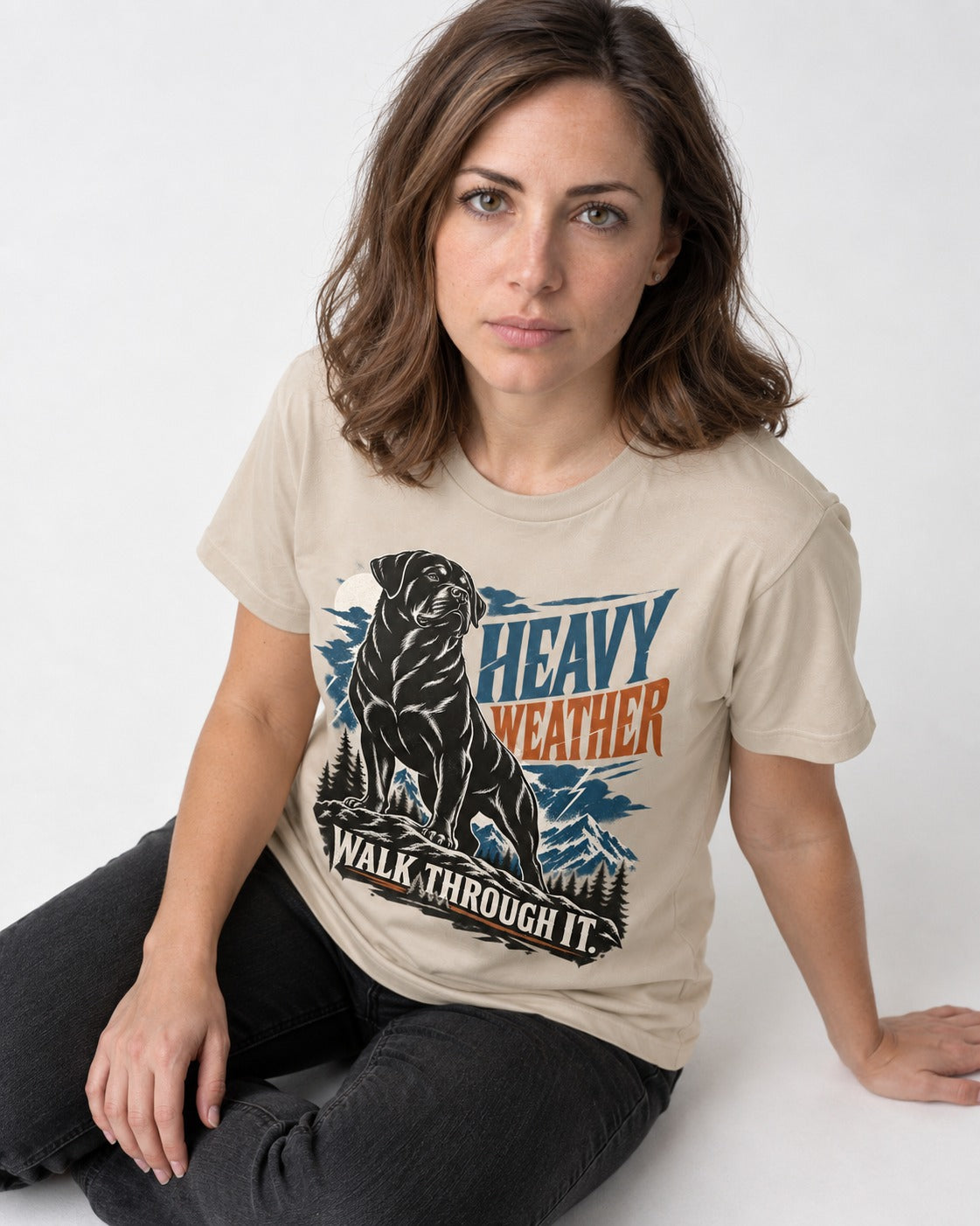 Heavy Weather Rottweiler T-Shirt in Sand, worn by a seated model