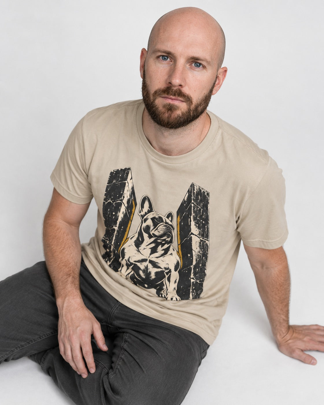 Frenchie Unbreakable T-Shirt in Sand, worn by a seated model