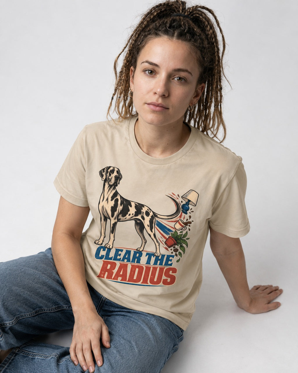 Great Dane Clear the Radius T-Shirt in Sand, worn by a seated model