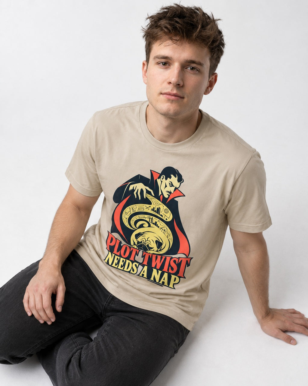 Pug Needs a Nap T-Shirt in Sand, worn by a seated model