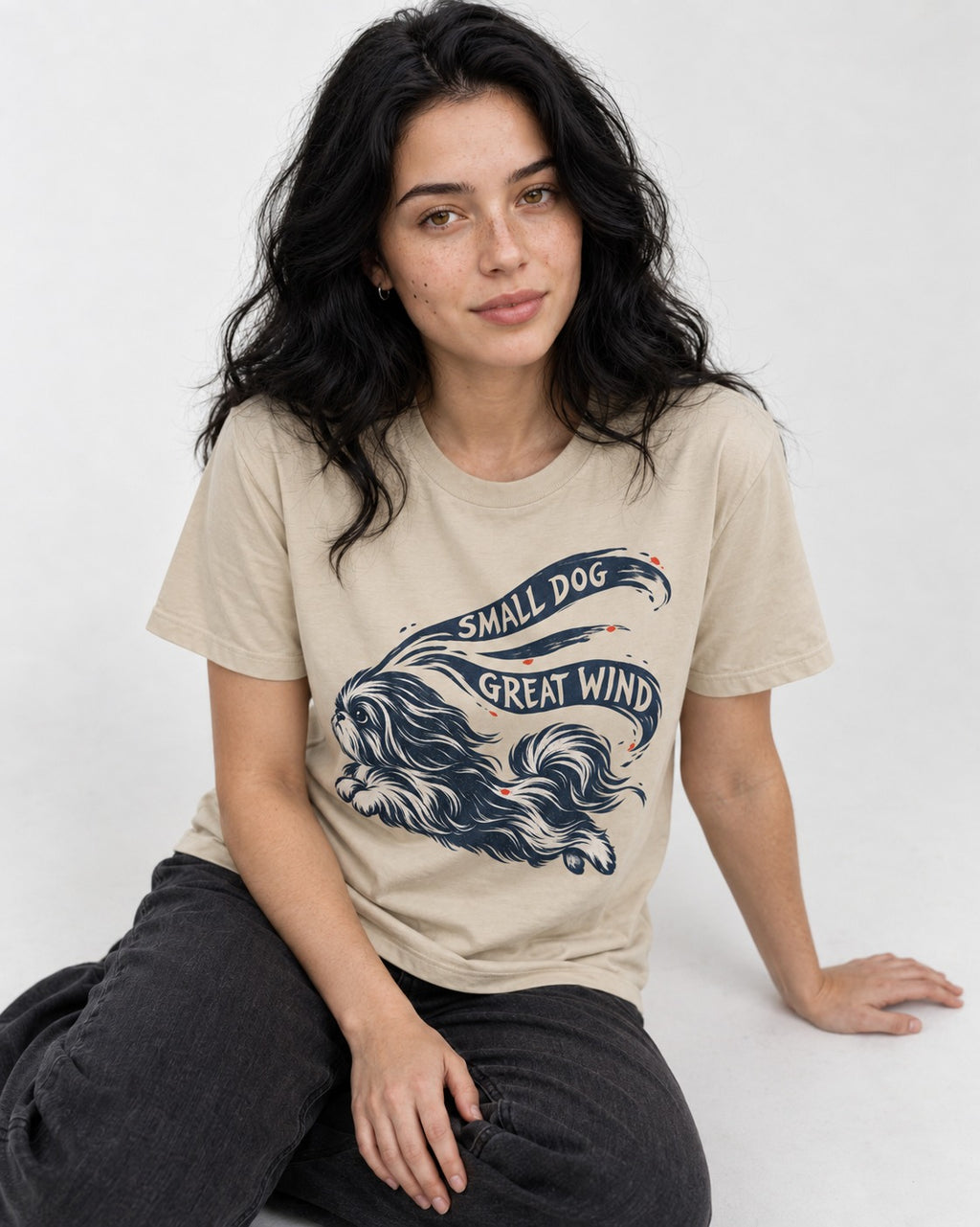 Small Shih Tzu Great Wind T-Shirt in Sand, worn by a seated model