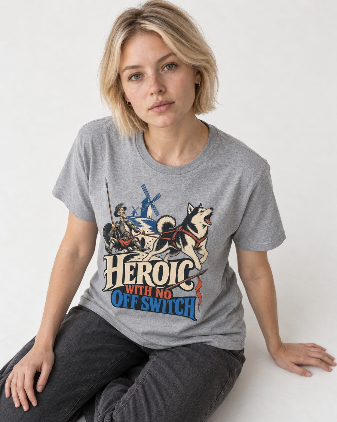 Husky Heroic with No Off Switch Don Quixote Graphic T-Shirt in Sport Grey, worn by a seated model