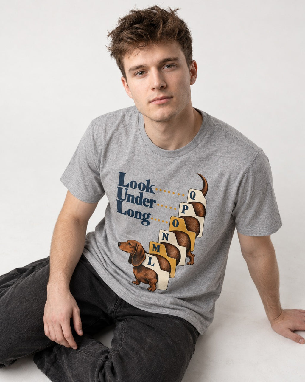 Look Under Long Dachshund T-Shirt in Sport Grey, worn by a seated model