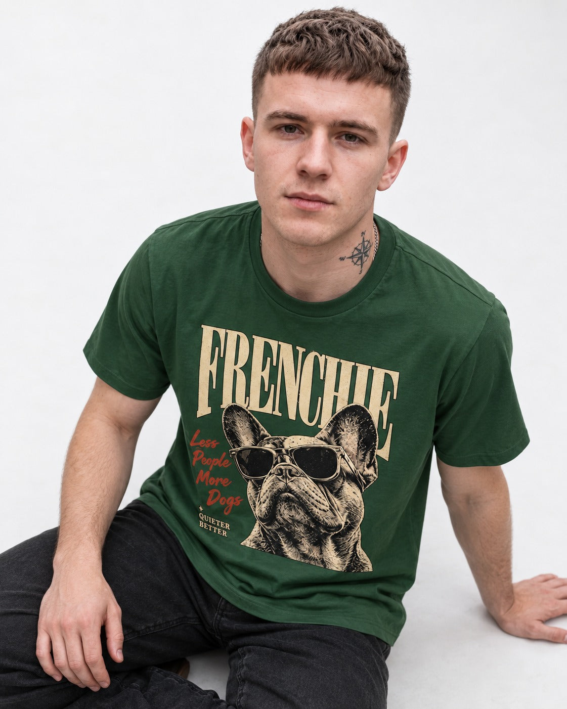 Frenchie Less People More Dogs Sunglasses Graphic T-Shirt in Forest Green, worn by a seated model