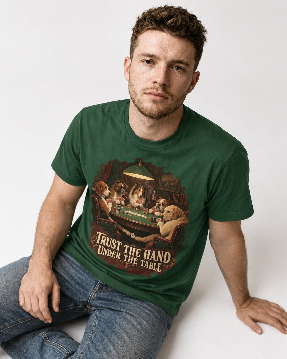 Labrador Retriever Trust the Hand Under the Table Poker Dogs Graphic T-Shirt in Forest Green, worn by a seated model