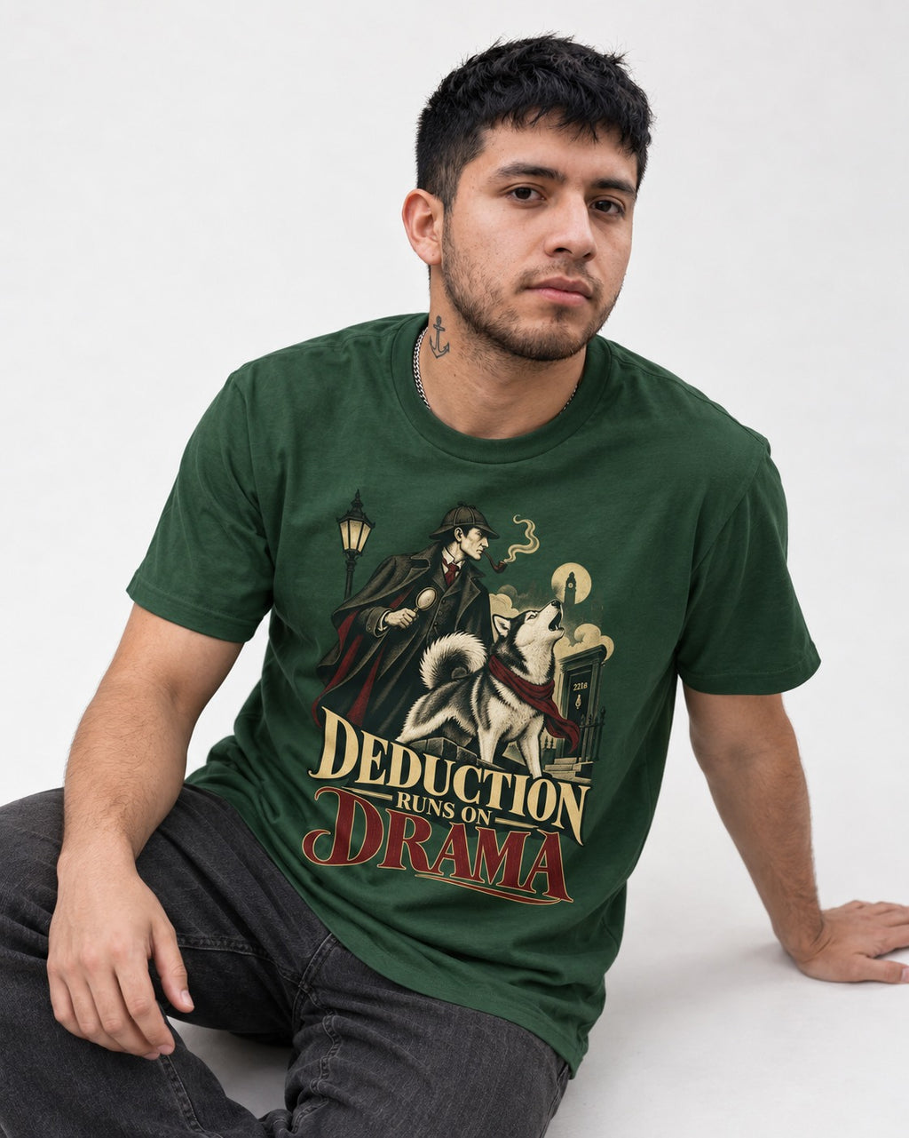 Husky Deduction Runs on Drama Detective Graphic T-Shirt in Forest Green, worn by a seated model