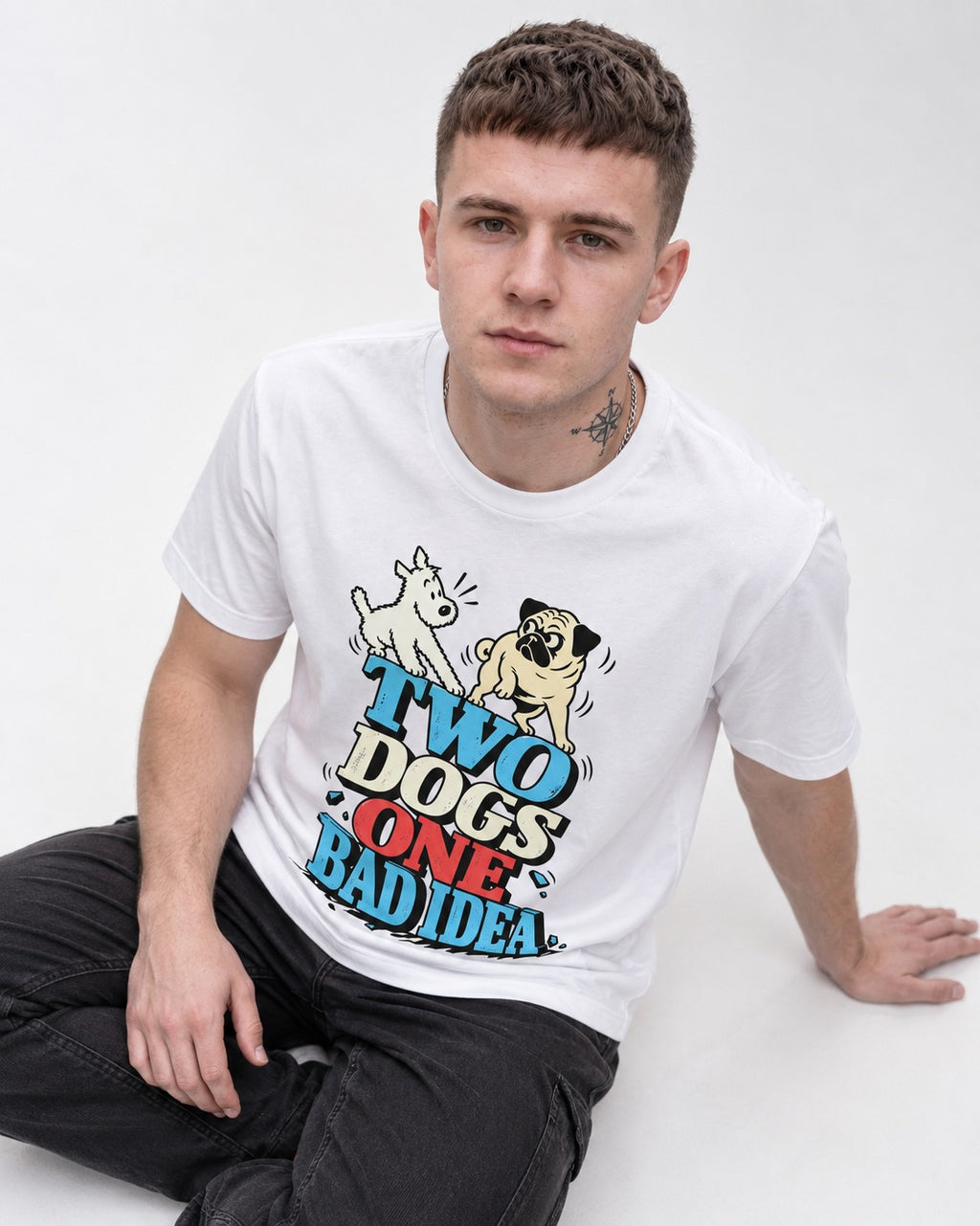 Pug Two Dogs One Bad Idea Graphic T-Shirt in White, worn by a seated model