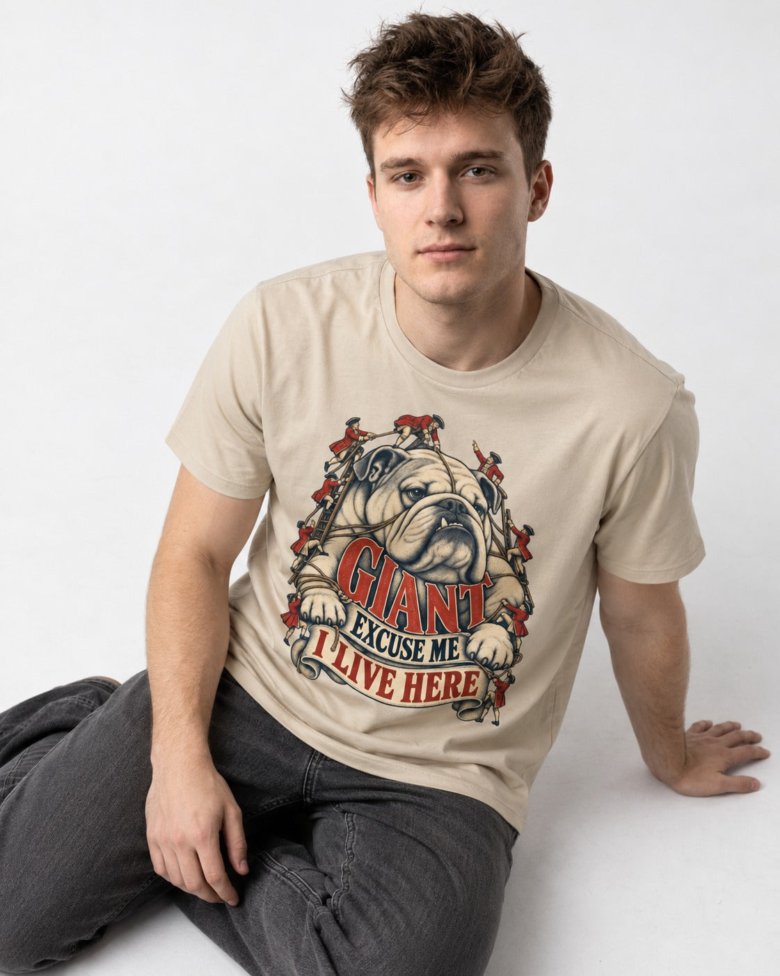 English Bulldog I Live Here T-Shirt in Sand, worn by a seated model