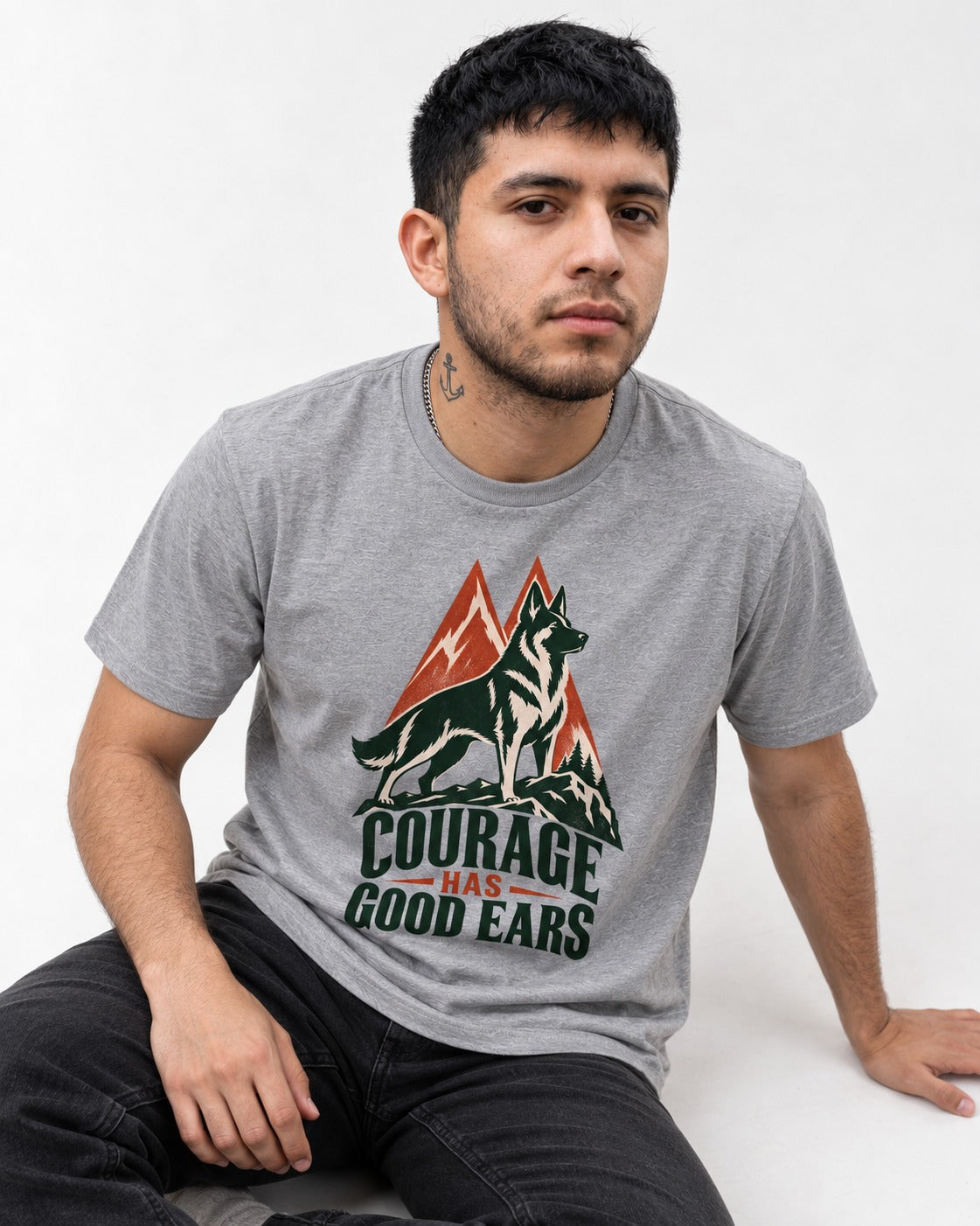 Courage Has Good Ears German Shepherd Dog T-Shirt in Sport Grey, worn by a seated model