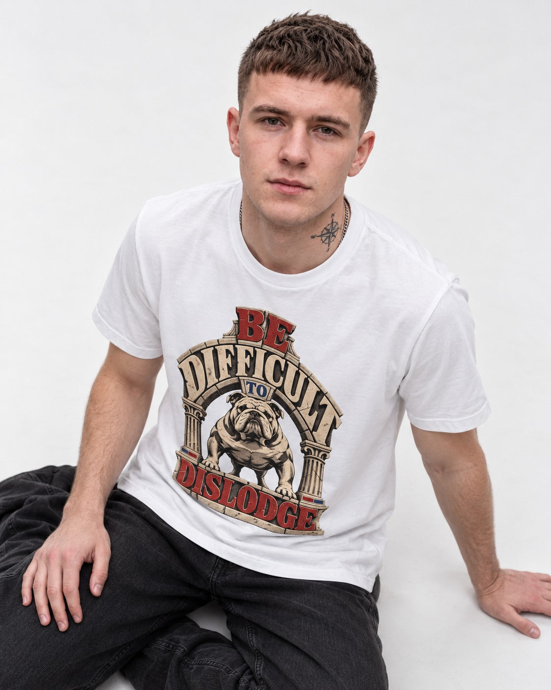 English Bulldog Be Difficult to Dislodge Stone Arch Graphic T-Shirt in White, worn by a seated model