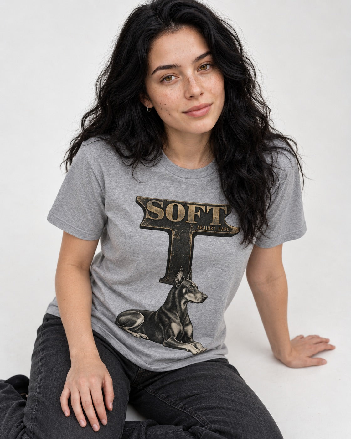 Soft Against Hard Doberman T-Shirt in Sport Grey, worn by a seated model