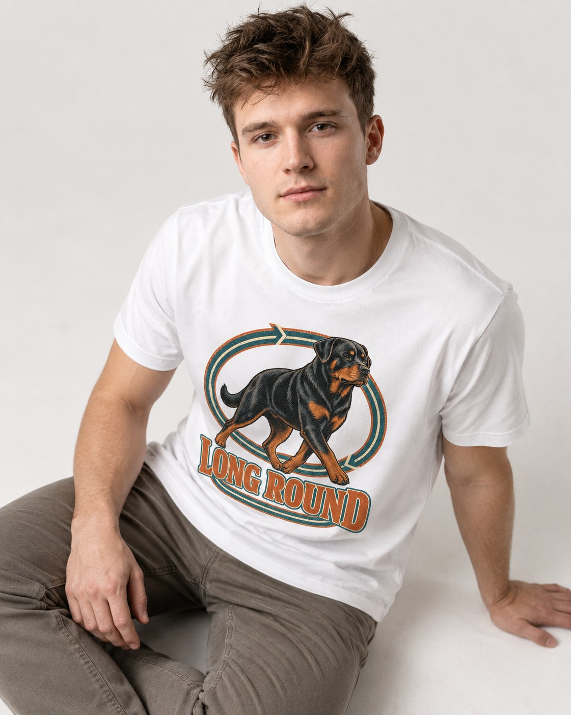 Rottweiler Long Round Circular Track Graphic T-Shirt in White, worn by a seated model
