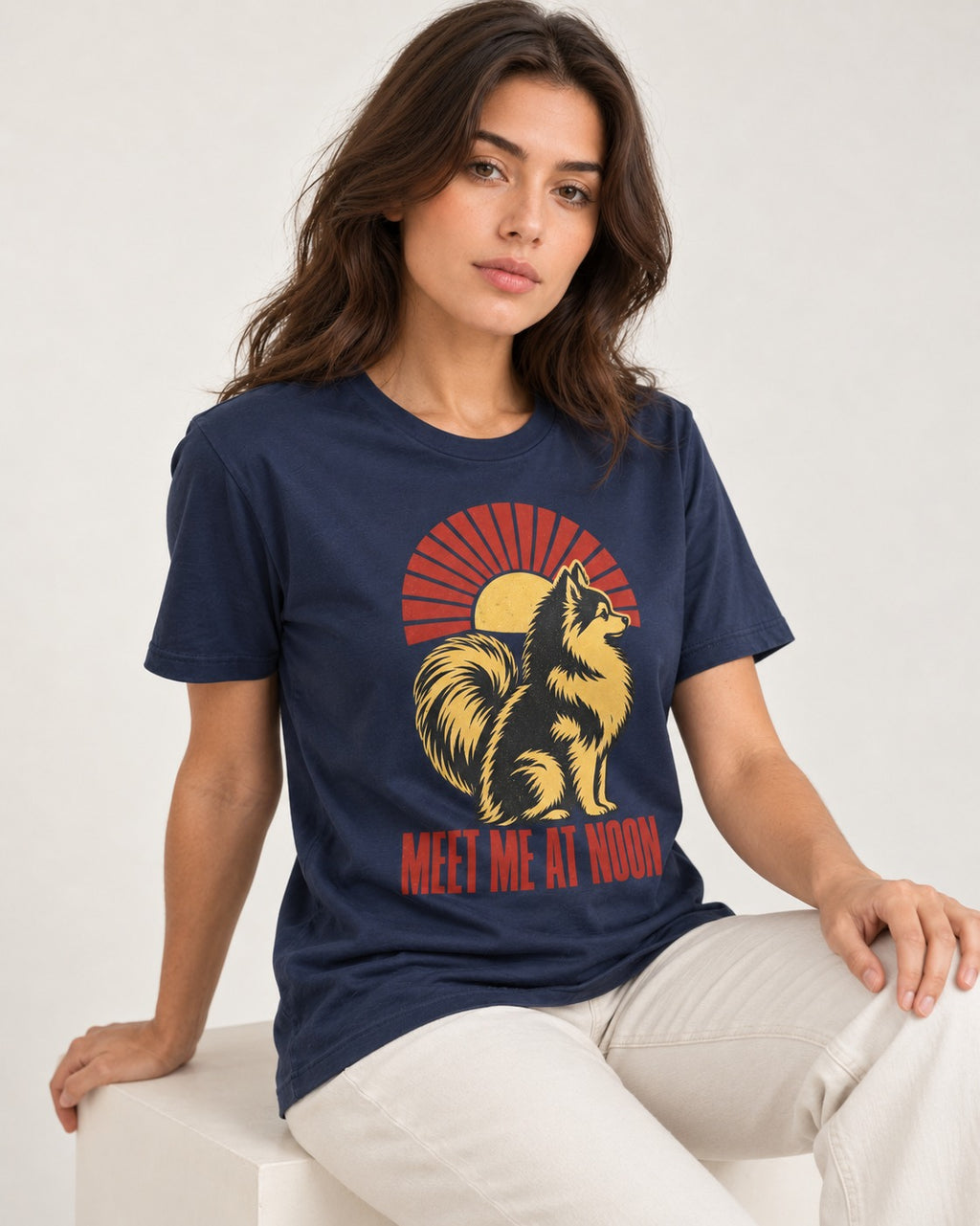 Pomeranian Meet Me at Noon Sunburst Graphic T-Shirt in Navy, worn by a seated model