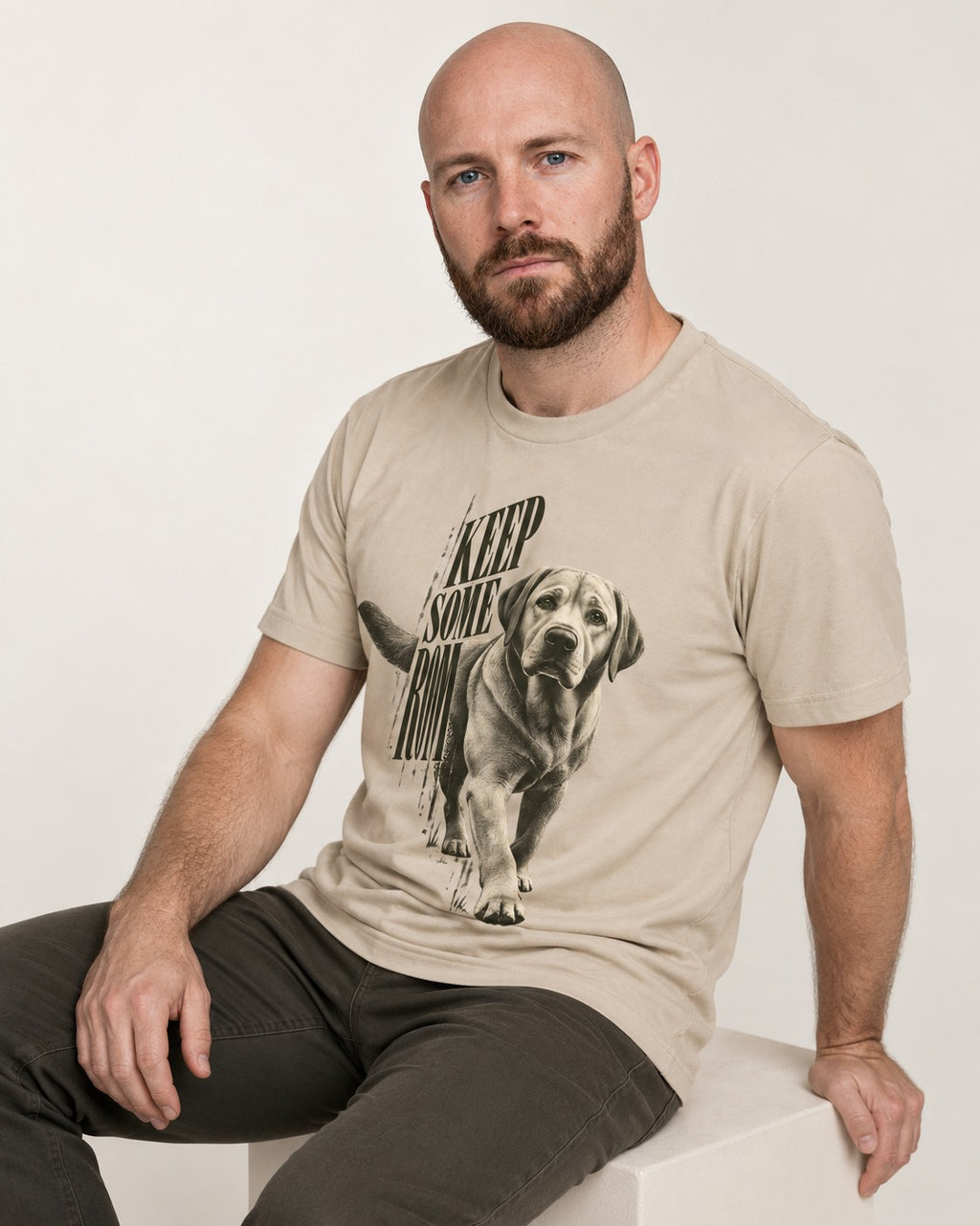 Keep Some Room Labrador Retriever T-Shirt in Sand, worn by a seated model