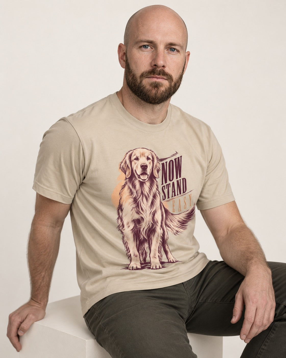 Now Stand Easy Golden Retriever T-Shirt in Sand, worn by a seated model
