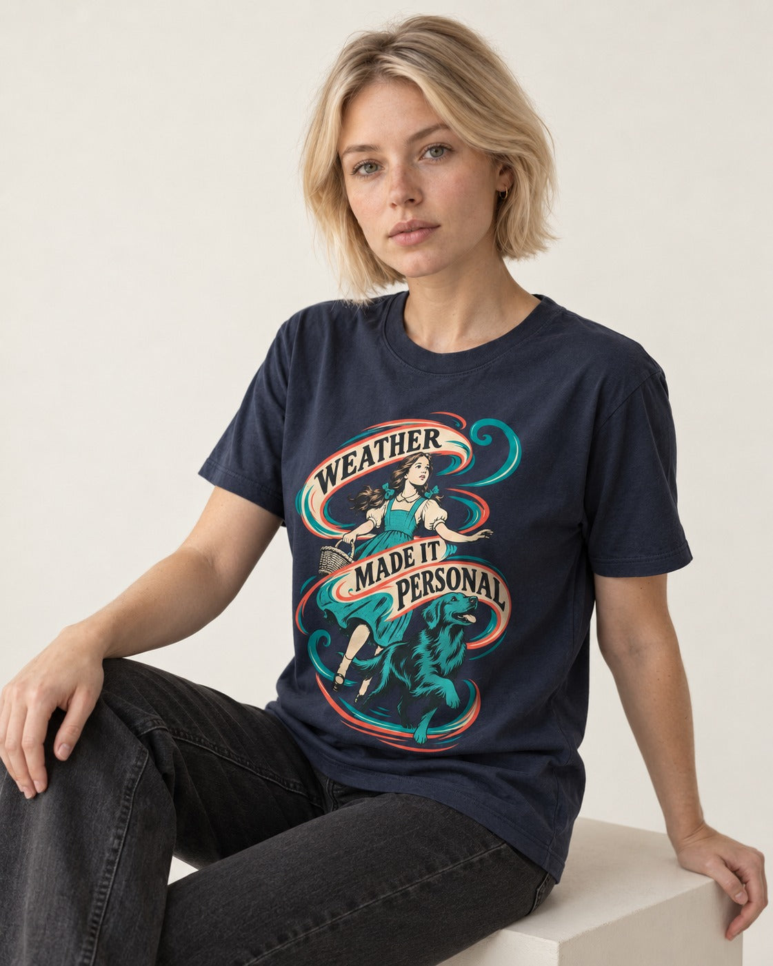 Golden Retriever Weather Made It Personal Woman Graphic T-Shirt in Navy, worn by a seated model