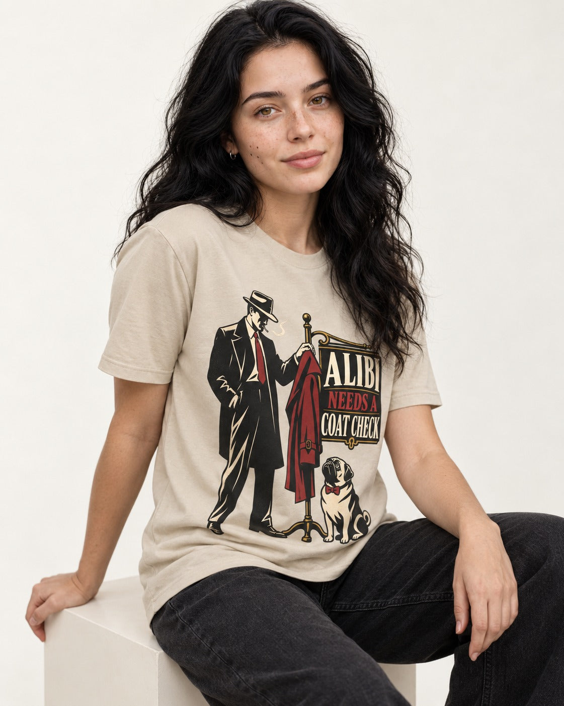 Pug Alibi Needs Coat Check T-Shirt in Sand, worn by a seated model