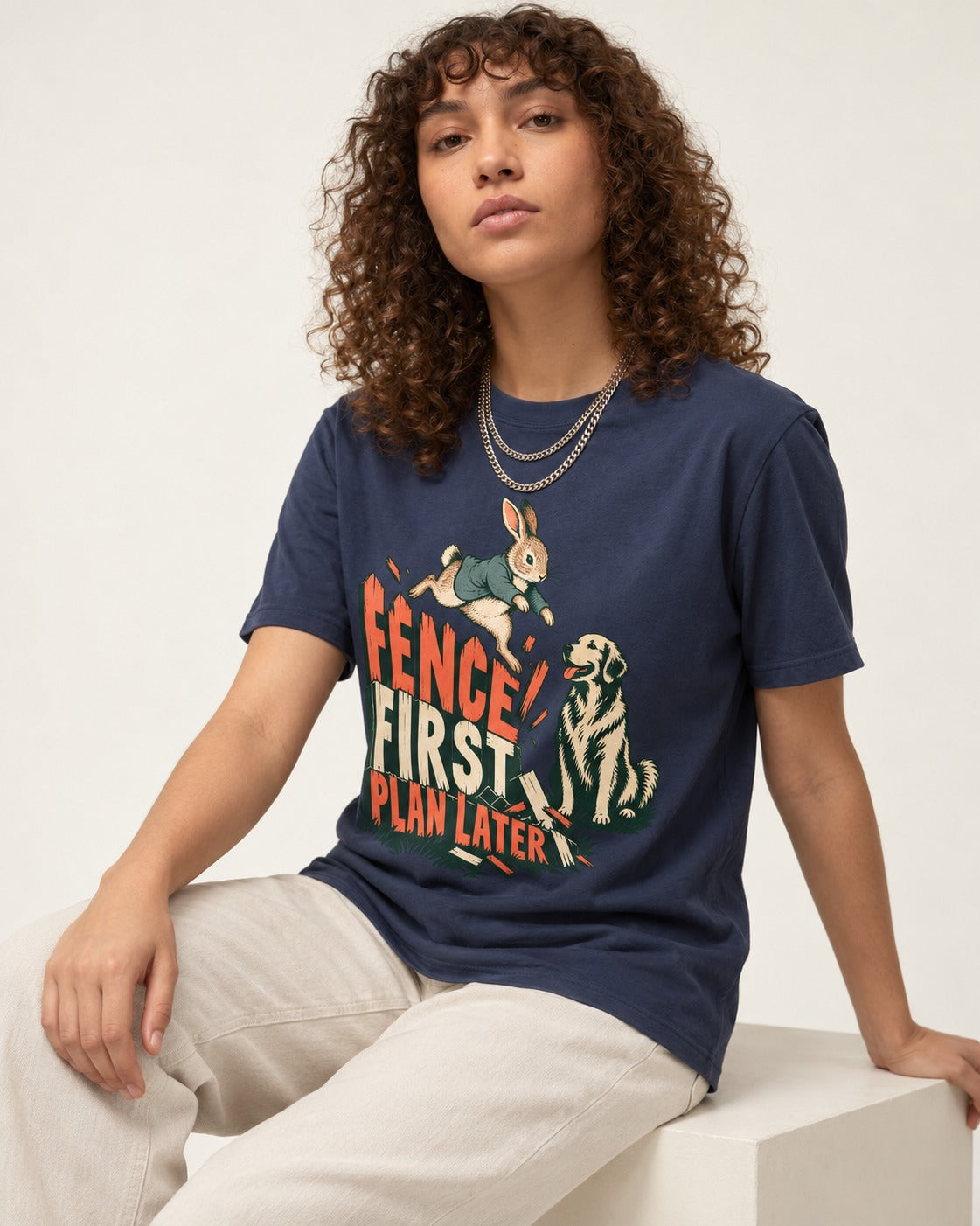 Golden Retriever Fence First Plan Later Rabbit Jump Graphic T-Shirt in Navy, worn by a seated model