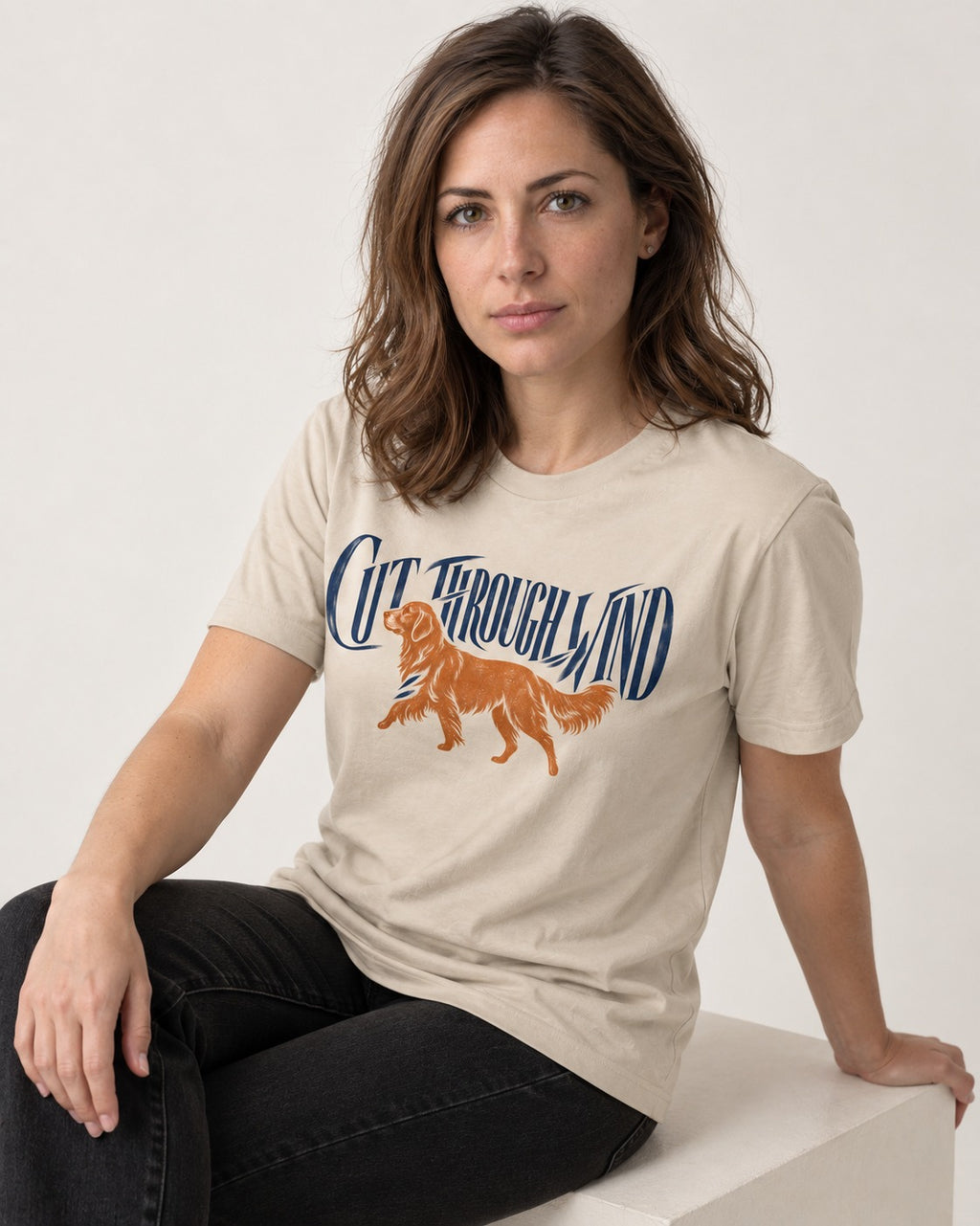 Golden Retriever Cut Through Land T-Shirt in Sand, worn by a seated model