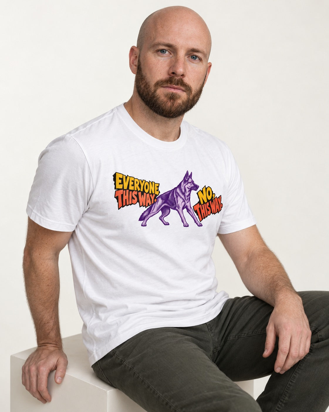 German Shepherd Dog Everyone This Way No This Way Direction Graphic T-Shirt in White, worn by a seated model