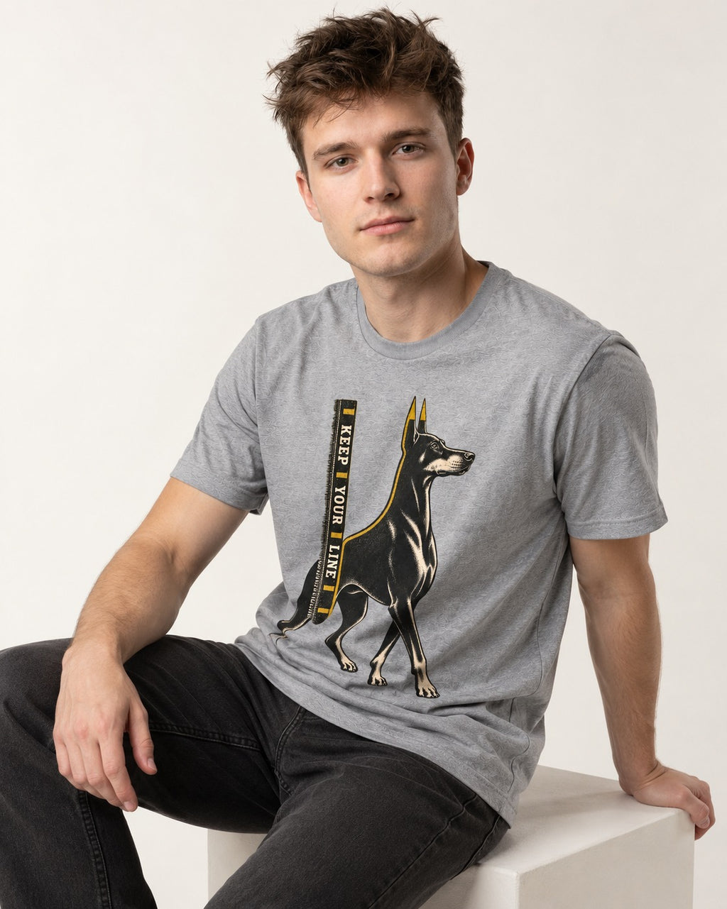 Keep Your Line Doberman T-Shirt in Sport Grey, worn by a seated model