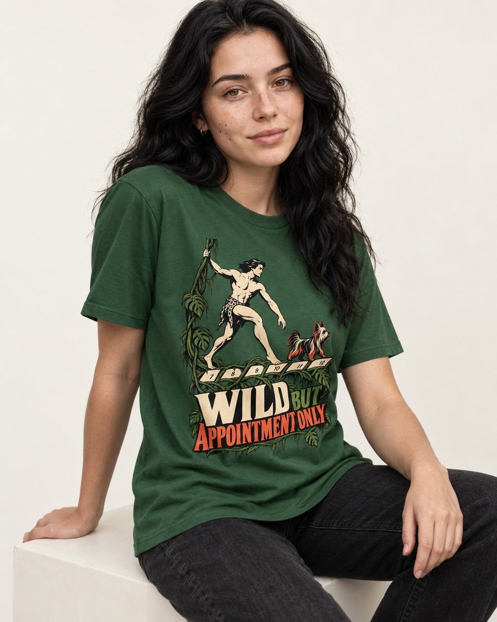 Yorkshire Terrier Wild but Appointment Only Jungle Calendar Graphic T-Shirt in Forest Green, worn by a seated model