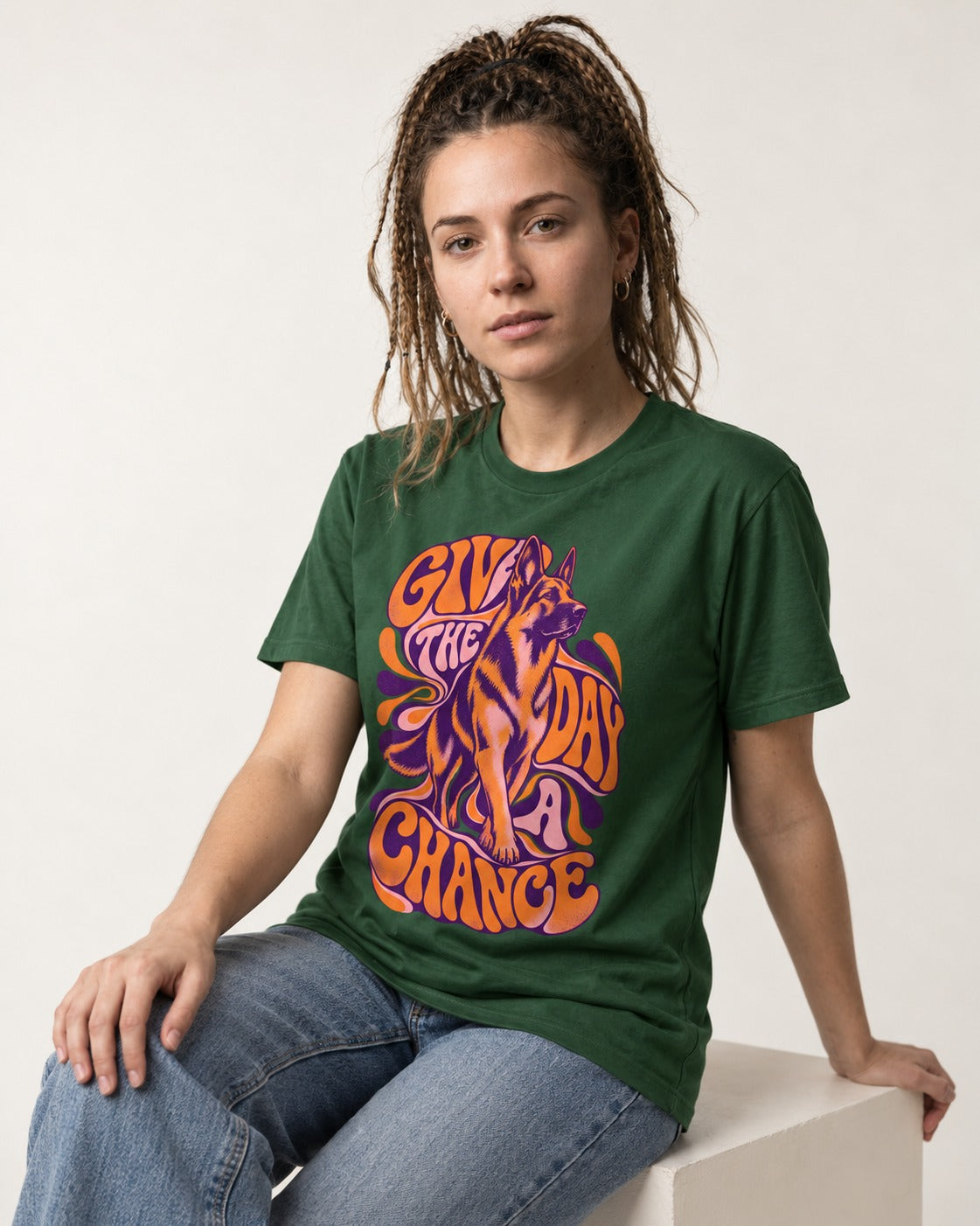 Give The Day A Chance Psychedelic German Shepherd Dog Graphic T-Shirt in Forest Green, worn by a seated model