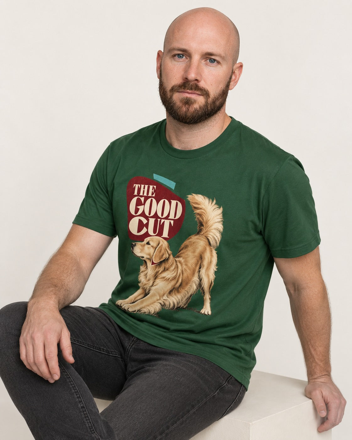 Golden Retriever The Good Cut Play Bow Graphic T-Shirt in Forest Green, worn by a seated model