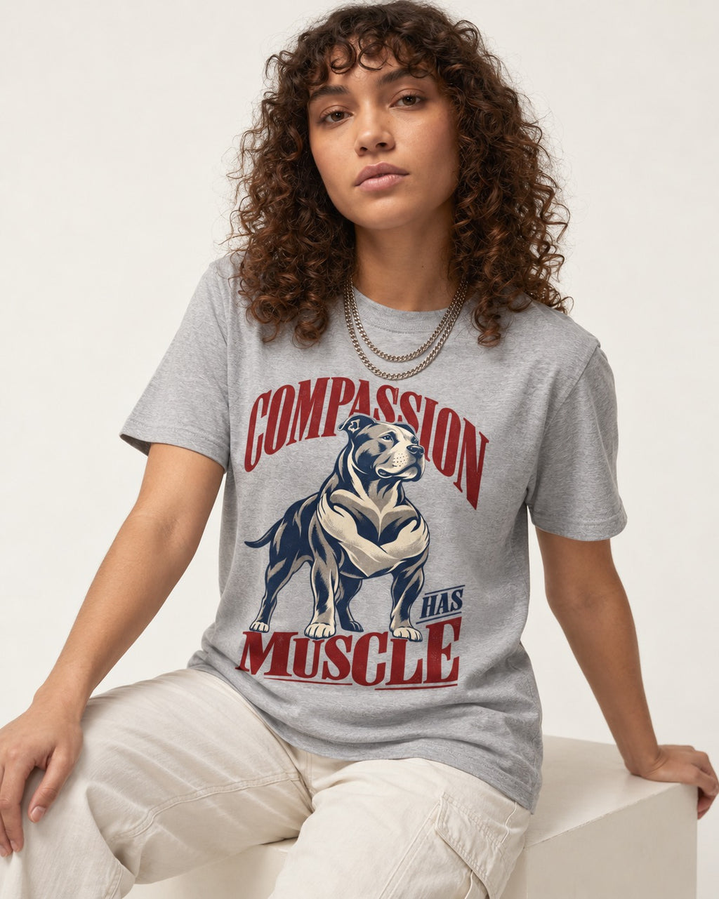 Pitbull Compassion Has Muscle T-Shirt in Sport Grey, worn by a seated model