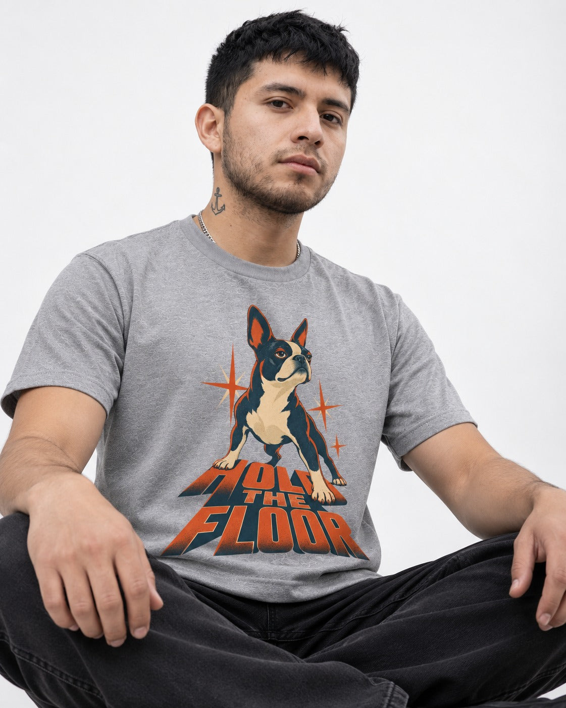 Boston Terrier On The Floor Perspective Graphic T-Shirt in Sport Grey, worn by a seated model