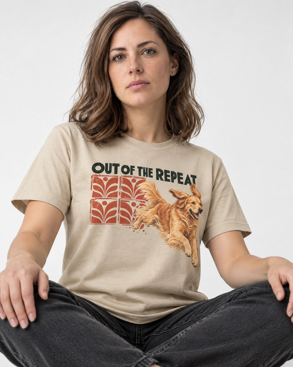 Golden Retriever Out of the Repeat T-Shirt in Sand, worn by a seated model