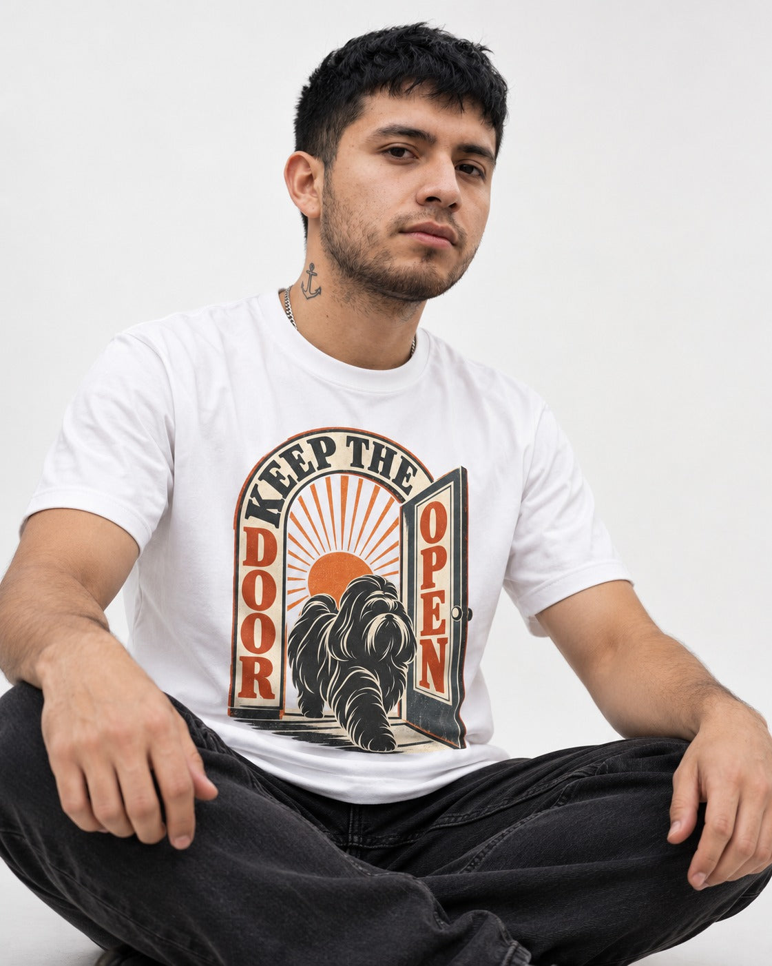 Shih Tzu Keep the Door Open Retro Doorway Graphic T-Shirt in White, worn by a seated model