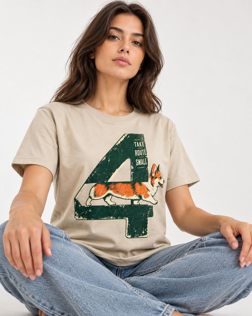 Take Route Small Corgi T-Shirt in Sand, worn by a seated model