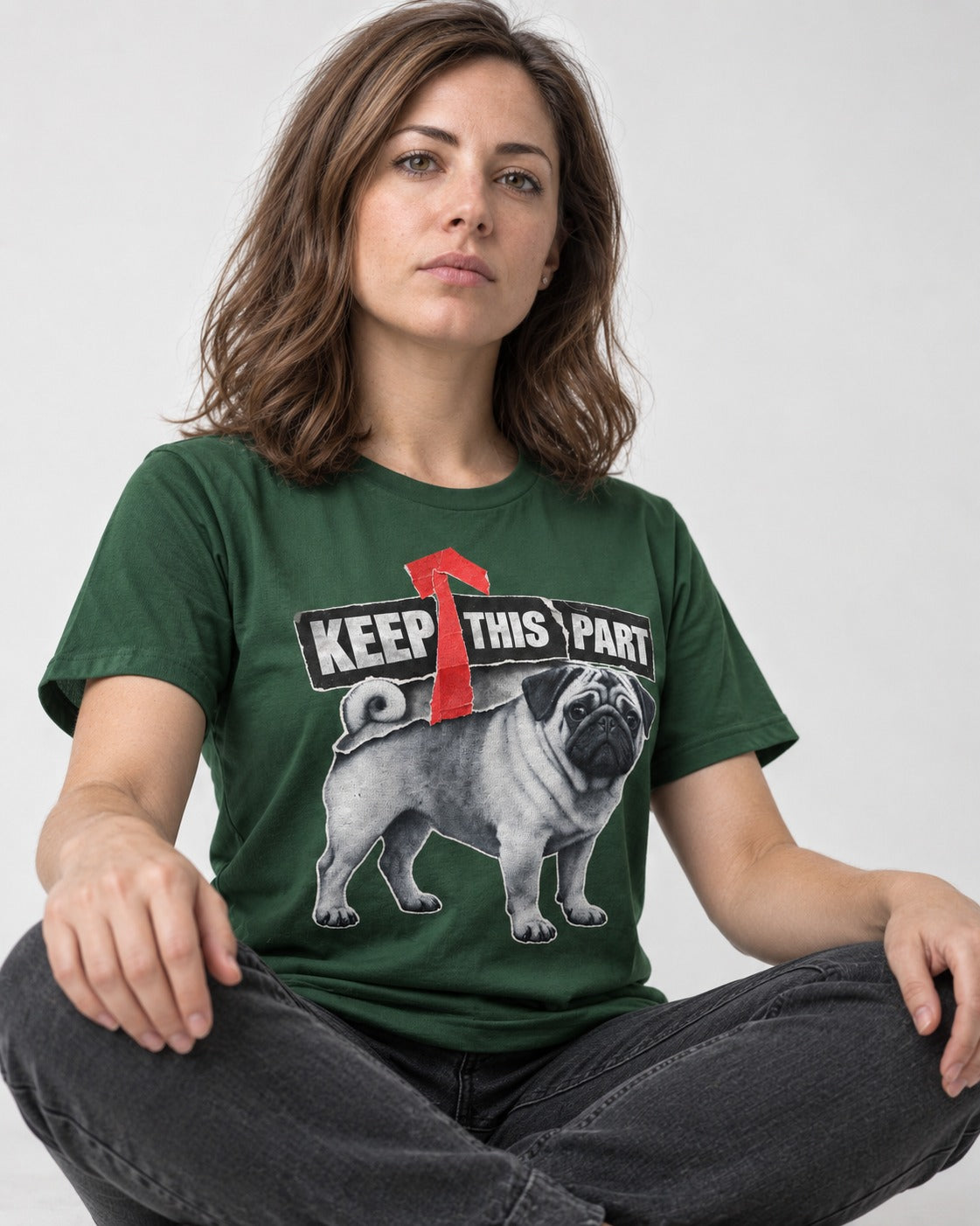 Pug Keep This Part Tape Arrow Graphic T-Shirt in Forest Green, worn by a seated model