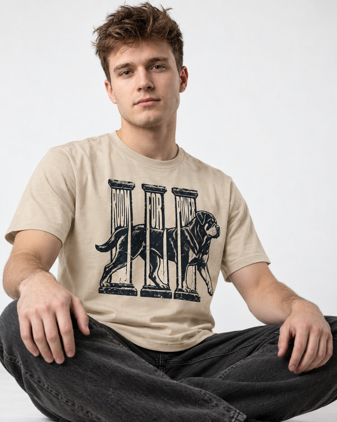 Room for Rottweiler Power T-Shirt in Sand, worn by a seated model