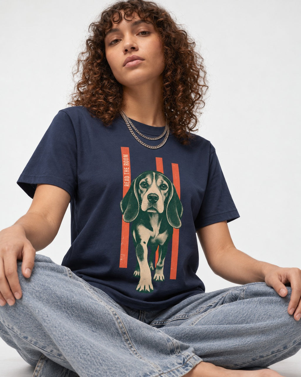 Beagle Before The Move Walking Portrait T-Shirt in Navy, worn by a seated model