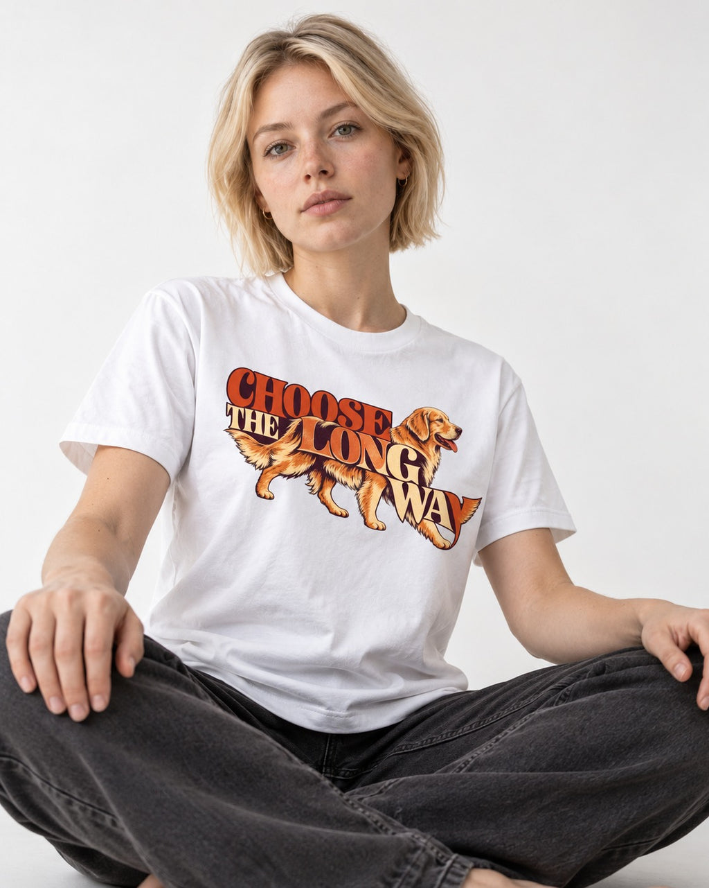 Golden Retriever Choose The Long Way Retro Graphic T-Shirt in White, worn by a seated model