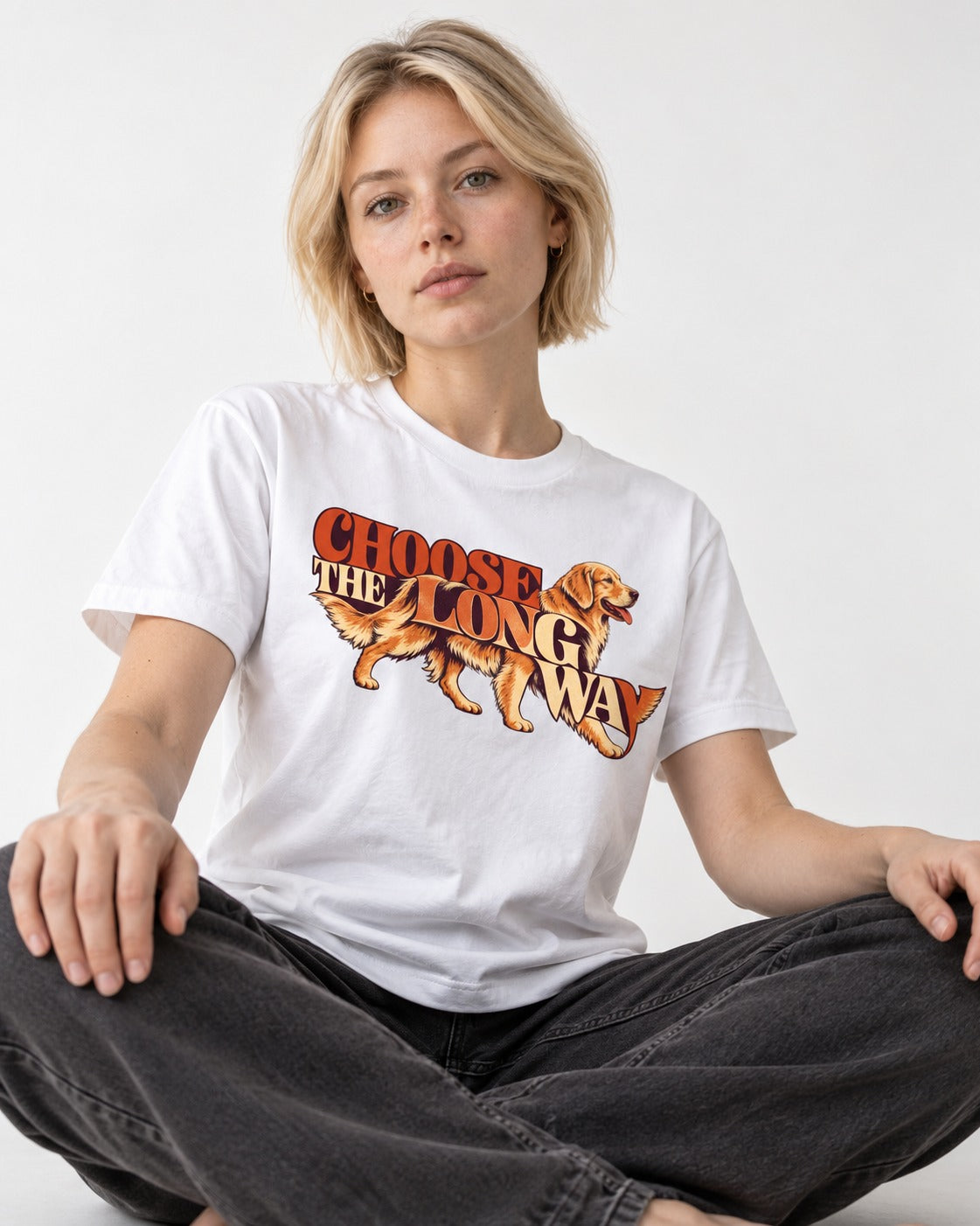 Golden Retriever Choose The Long Way Retro Graphic T-Shirt in White, worn by a seated model