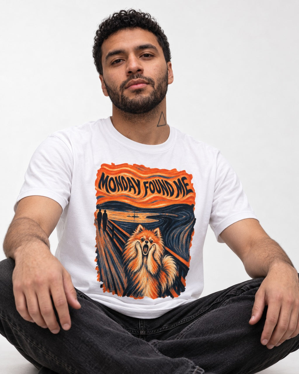 Pomeranian Monday Found Me Scream Parody Graphic T-Shirt in White, worn by a seated model