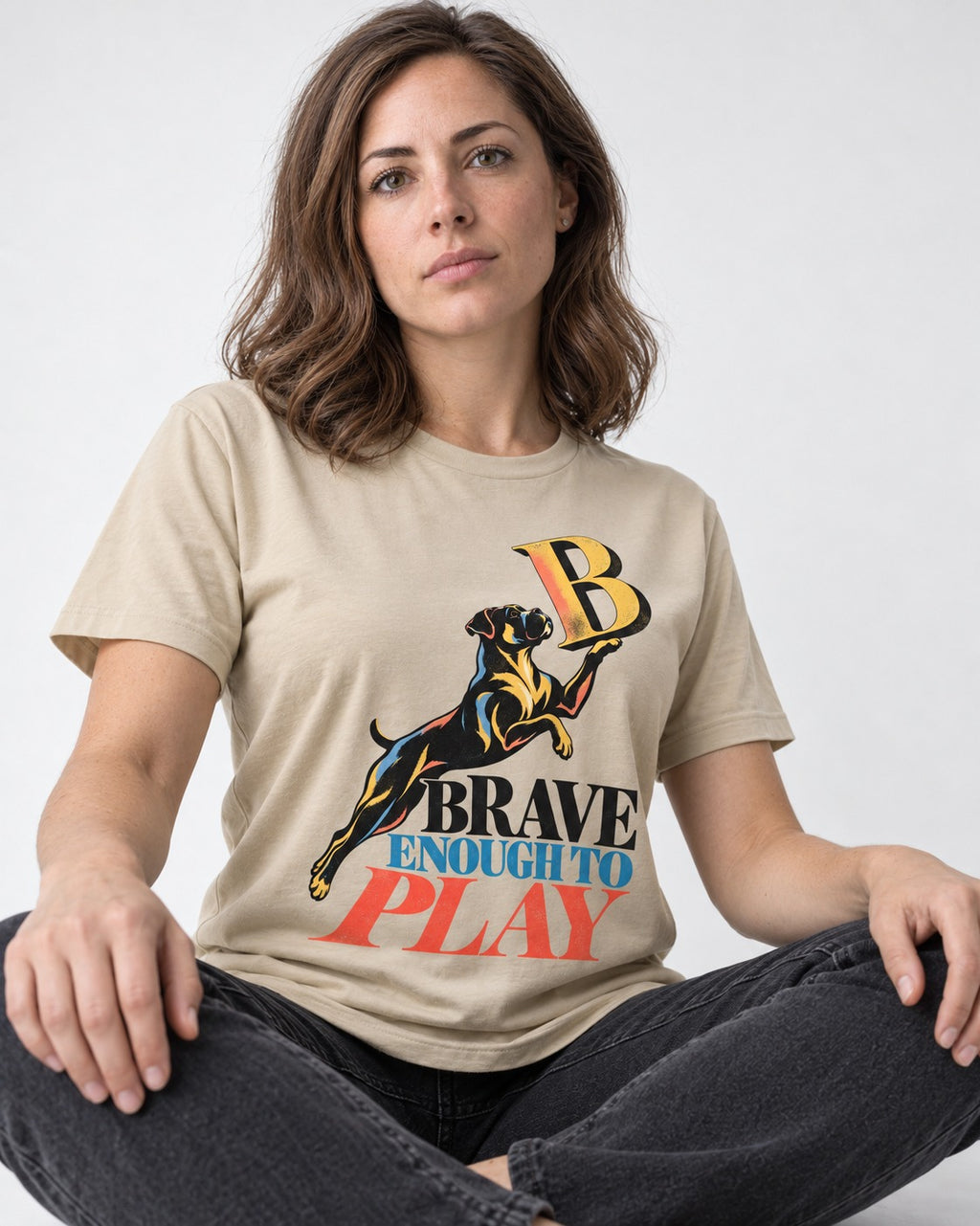 Boxer Brave Enough to Play T-Shirt in Sand, worn by a seated model
