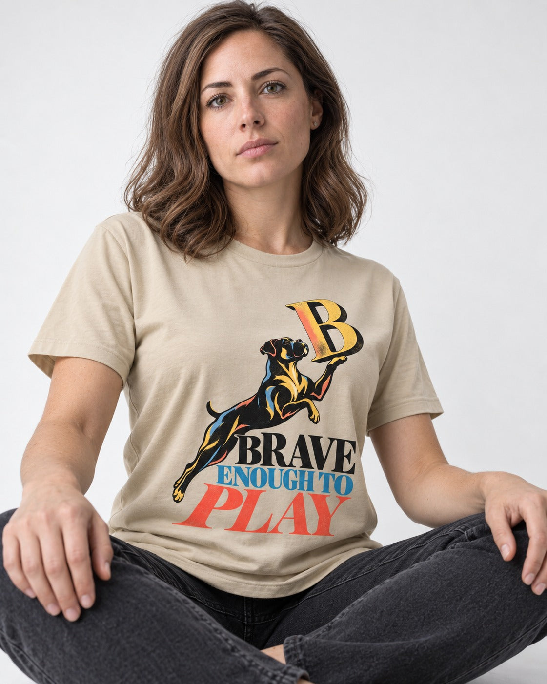 Boxer Brave Enough to Play T-Shirt in Sand, worn by a seated model
