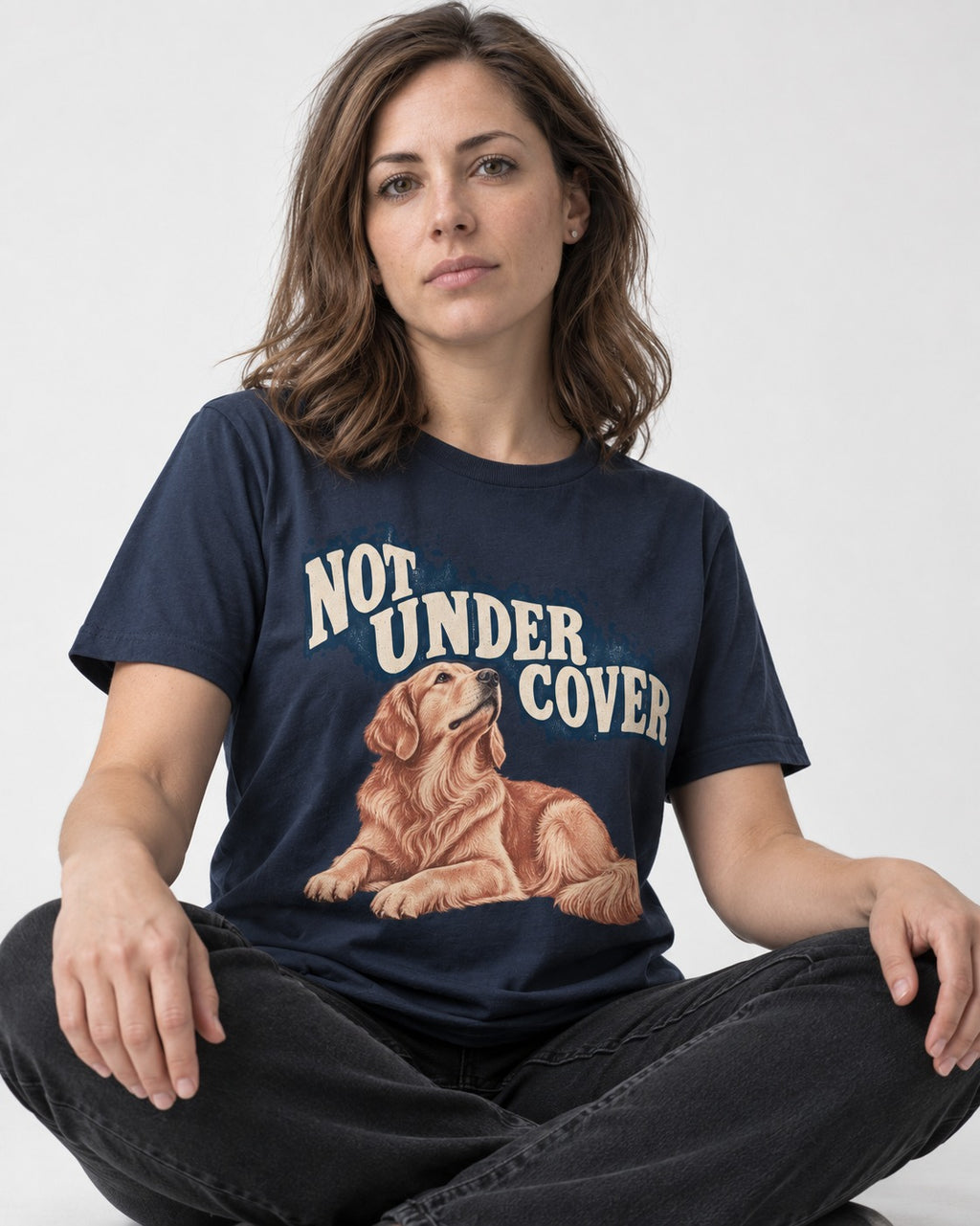 Not Under Cover Reclining Golden Retriever Graphic T-Shirt in Navy, worn by a seated model