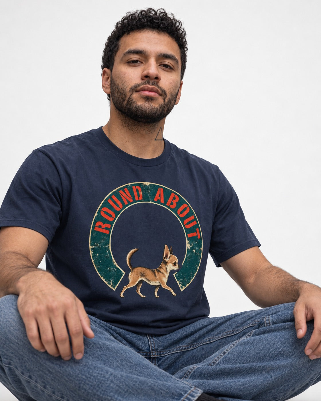 Round About Chihuahua Emblem Graphic T-Shirt in Navy, worn by a seated model