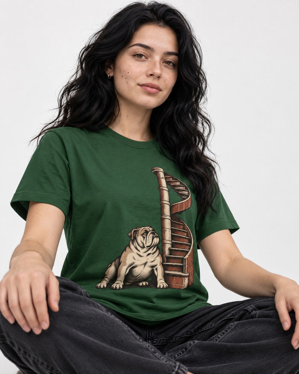 English Bulldog Spiral Staircase Graphic T-Shirt in Forest Green, worn by a seated model