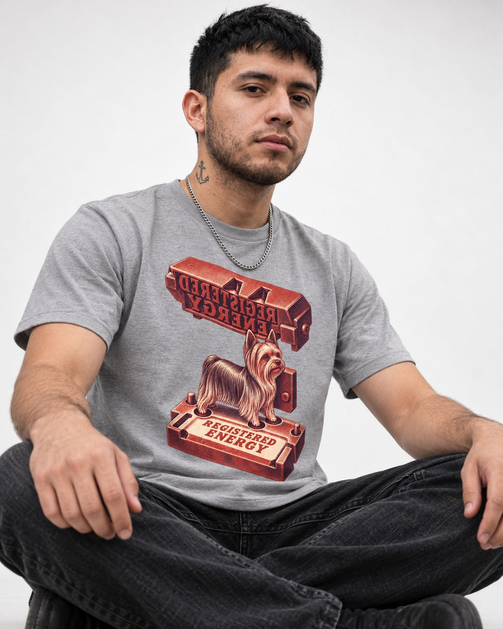 Yorkshire Terrier Registered Energy Stamp Press Graphic T-Shirt in Sport Grey, worn by a seated model
