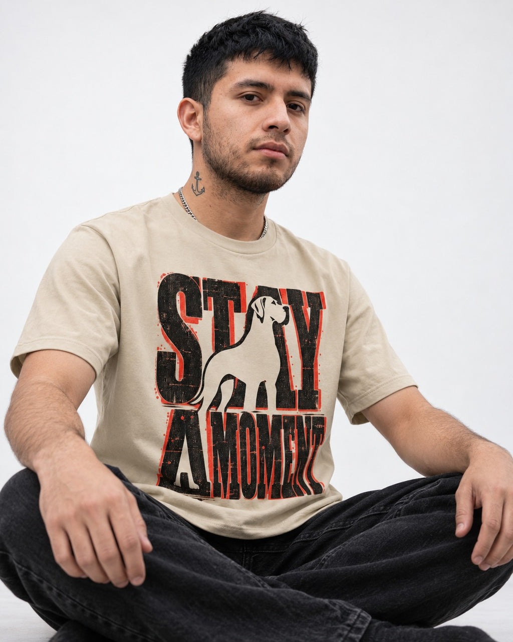 Stay a Moment Great Dane T-Shirt in Sand, worn by a seated model