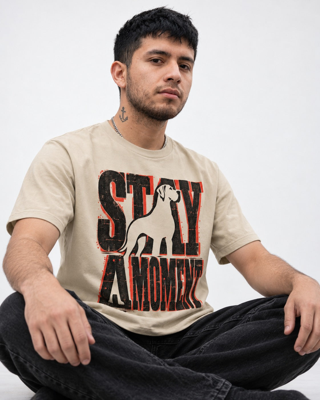 Stay a Moment Great Dane T-Shirt in Sand, worn by a seated model